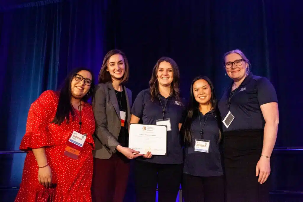 Certified Nonprofit Professional's smiling on a stage