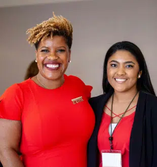 Two nonprofit professionals smiling together at a nonprofit management conference