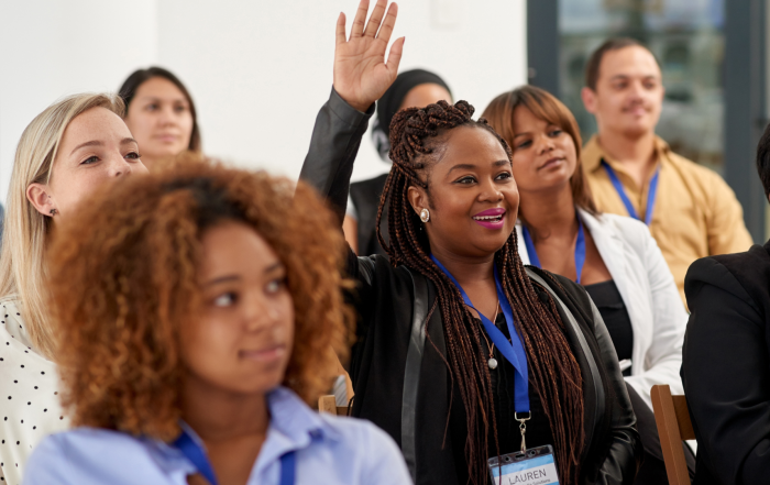 Group of diverse nonprofit professionals sitting together prioritizing attendee comfort during a conference learning session