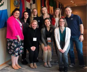 A group of nonprofit professionals smiling at an in person nonprofit training conference