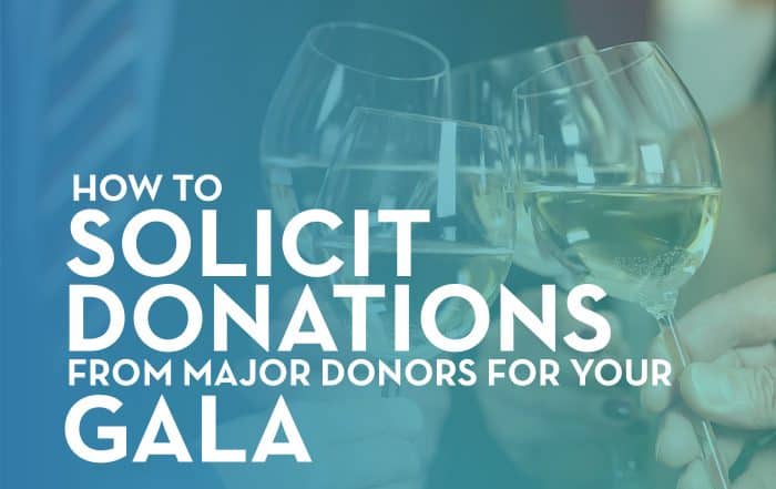 four individuals hitting their wine glasses together in celebration during a fundraising gala