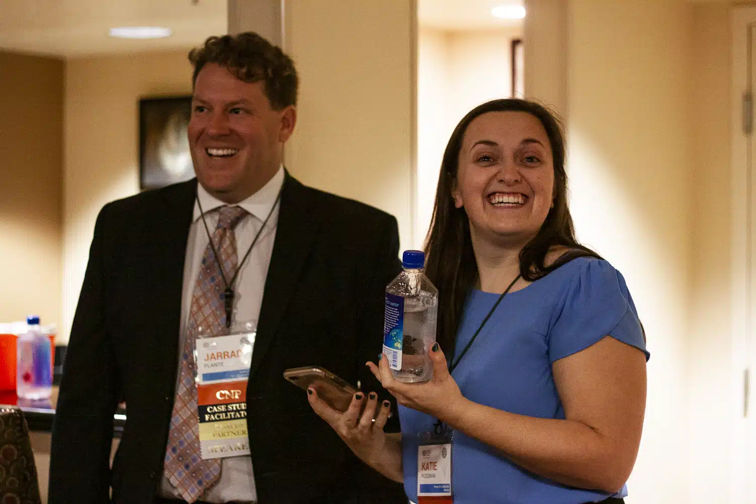 Two nonprofit professionals laughing together at a professional conference