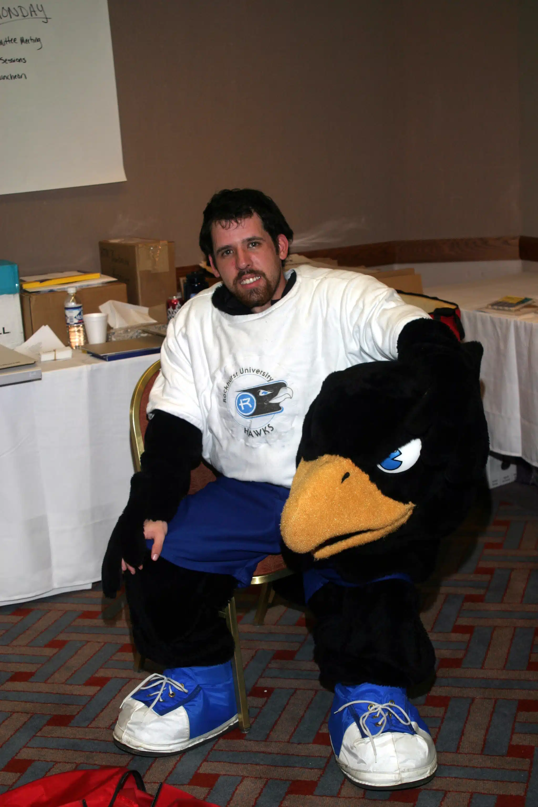 Rockhurst University mascot sitting on a chair