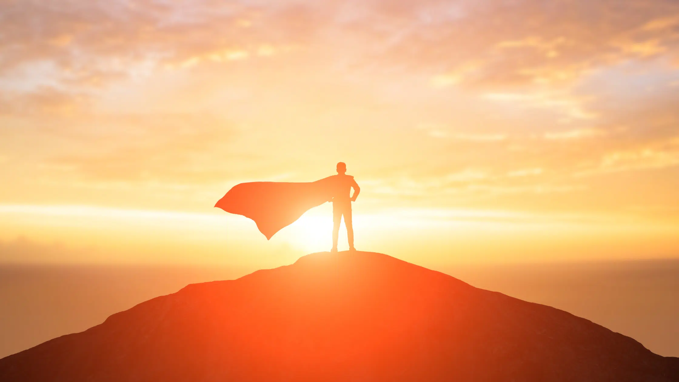 Courageous leader standing on top of a mountain