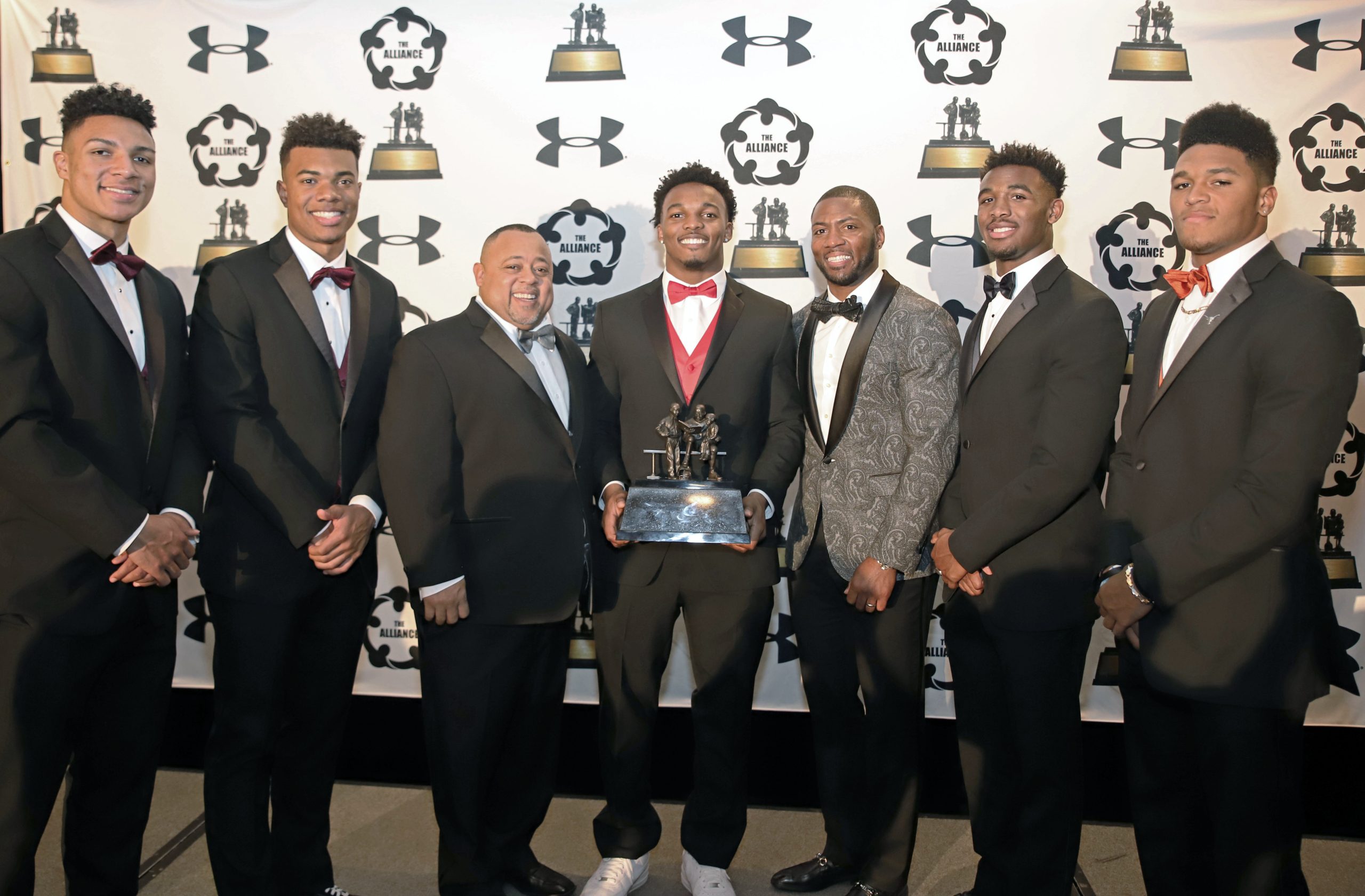 A group of african american student athletes celebrate being in the 2019 watkins award class