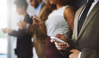 Group of professionals using their smartphones.