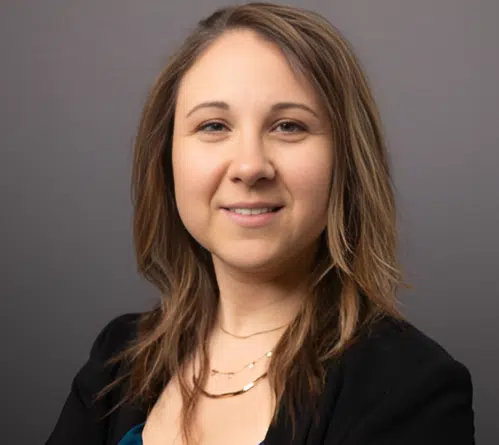 Stefanie O’Brien, CNP smiling in a black blazer and grey background