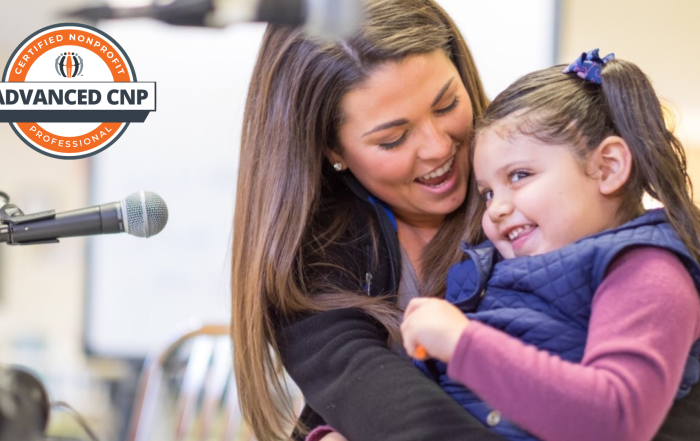 Carly St. Onge, ACNP, Chief Development Officer, Logan Health Children’s, shares a heartwarming moment with a young patient.