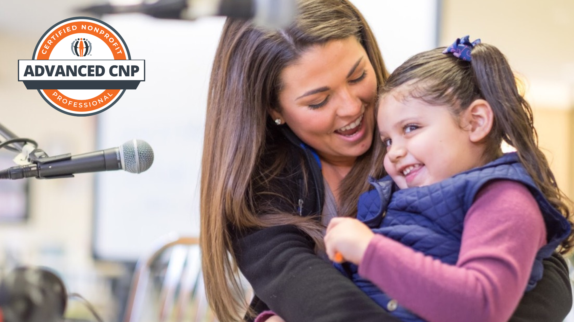 Carly St. Onge, ACNP, Chief Development Officer, Logan Health Children’s, shares a heartwarming moment with a young patient.