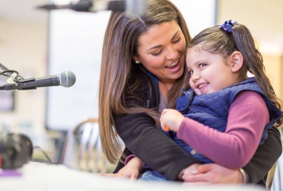 Chief Development Officer at Logan Health Children’s, Carly St. Onge, ACNP smiles brightly with a pediatric patient 