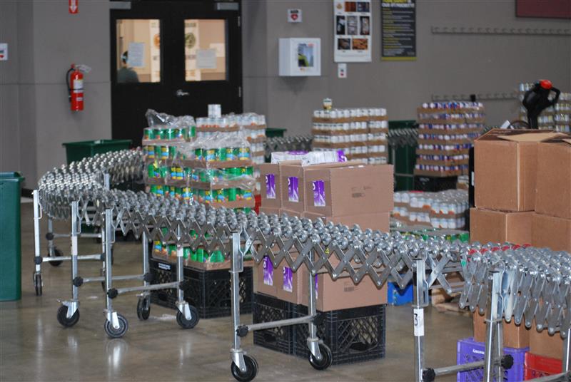 A well-organized conveyor belt station awaits for volunteers to quickly pack and prepare senior assistant boxes