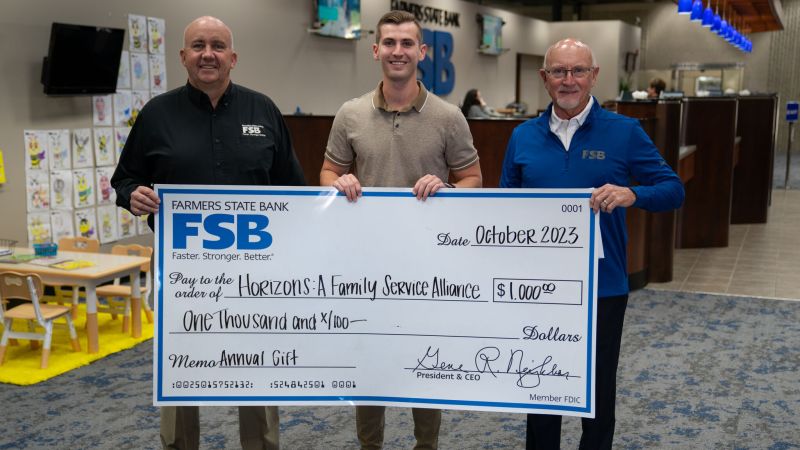 Chandler accepting a major donation in October 2023 during his former role at Horizons: A Family Service Alliance in Cedar Rapids, Iowa.