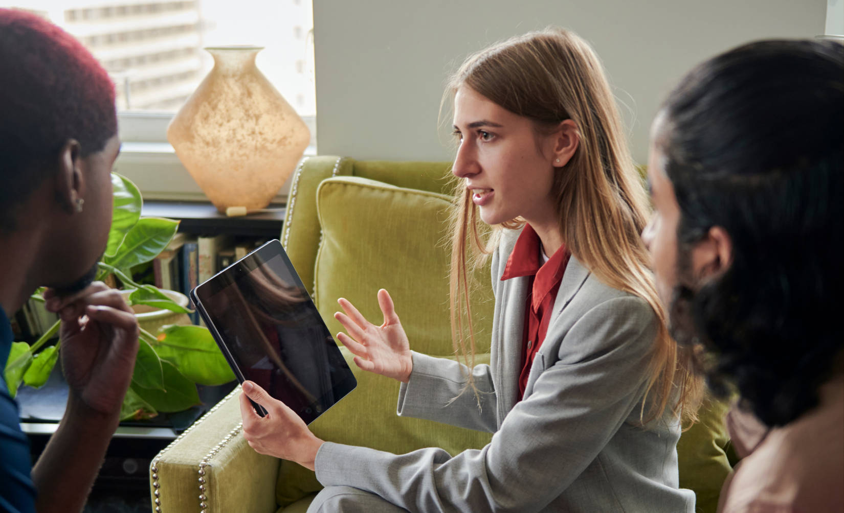 Nonprofit Professional holding an ipad speaking to the organization's reoccurring donors