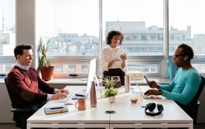A group of multigenerational nonprofit workers together in an office